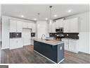 kitchen featuring hanging light fixtures, a kitchen island, and white cabinets