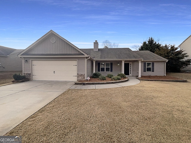 single story home with a garage and a front lawn