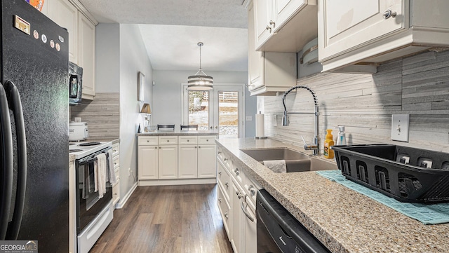 kitchen with pendant lighting, sink, black appliances, light stone countertops, and white cabinets