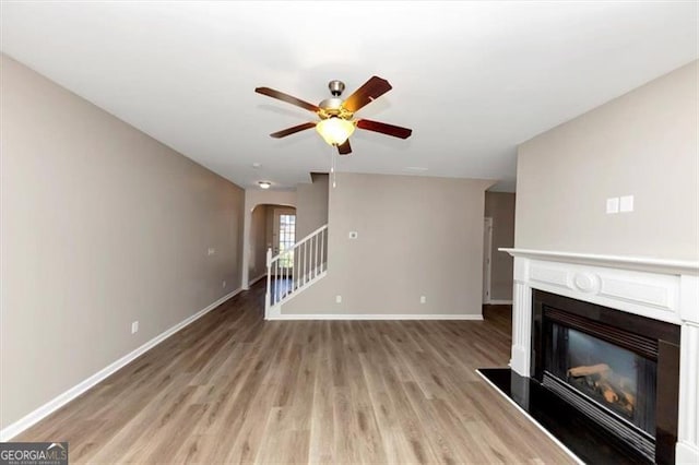 unfurnished living room with ceiling fan and light wood-type flooring