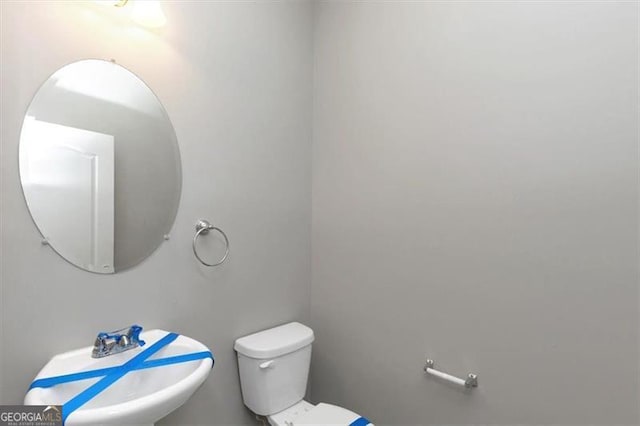 bathroom with toilet and sink