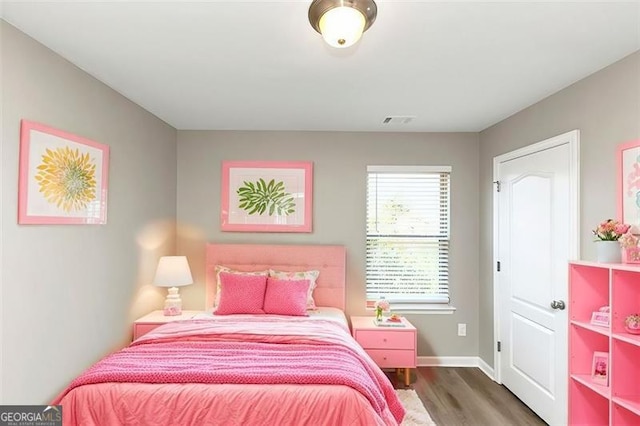 bedroom with dark wood-type flooring