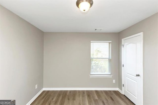 spare room featuring hardwood / wood-style floors