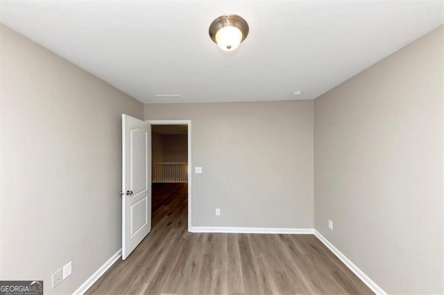 spare room with light hardwood / wood-style flooring