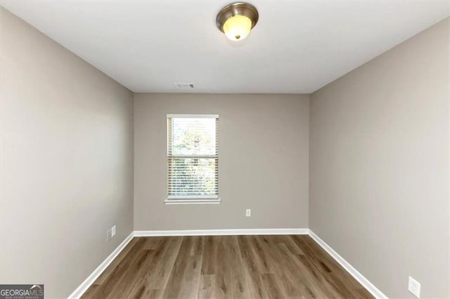 spare room featuring hardwood / wood-style flooring