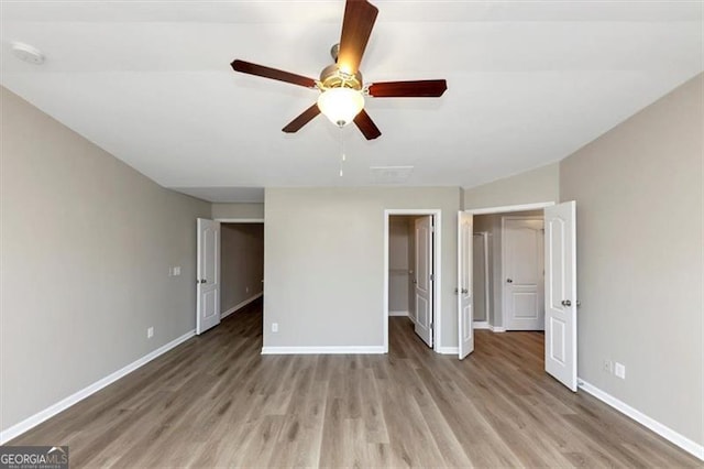 unfurnished bedroom with light hardwood / wood-style flooring, ceiling fan, and a closet