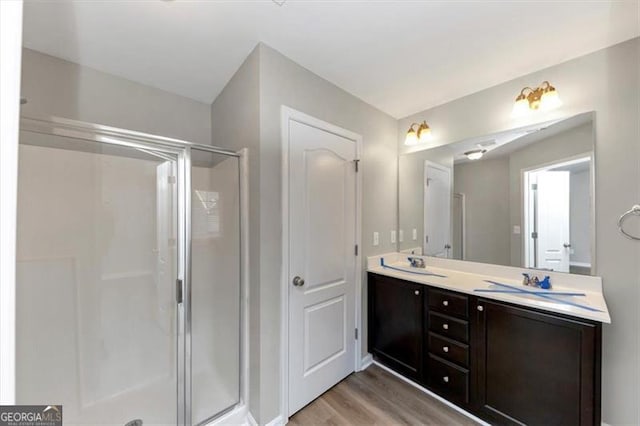 bathroom with vanity, wood-type flooring, and walk in shower