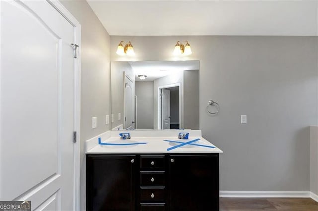 bathroom featuring vanity and wood-type flooring