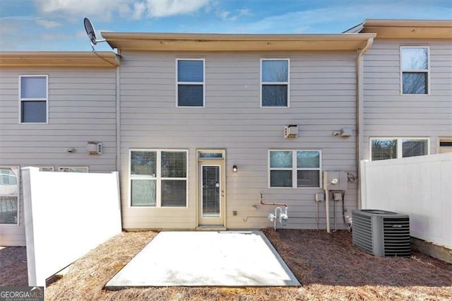 rear view of property featuring central AC and a patio