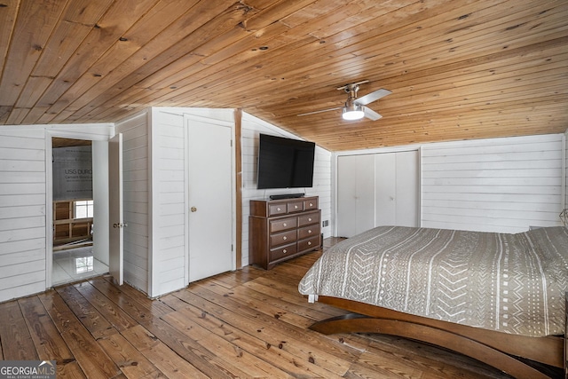 bedroom featuring wood ceiling, light hardwood / wood-style floors, and wood walls