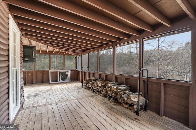 sunroom featuring beam ceiling