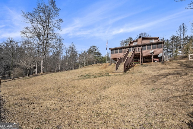 view of yard featuring a wooden deck and a sunroom