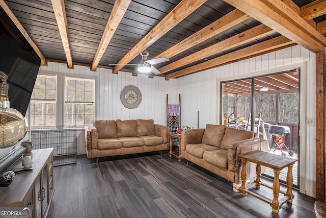 living room with dark hardwood / wood-style flooring and beamed ceiling