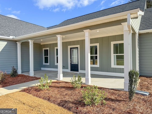 view of exterior entry with covered porch