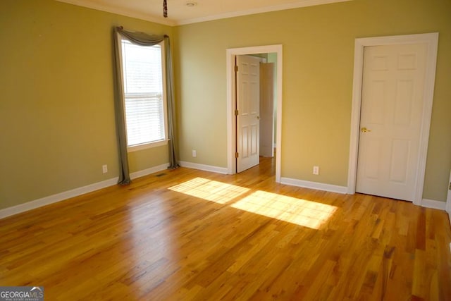 unfurnished bedroom with crown molding and light hardwood / wood-style floors