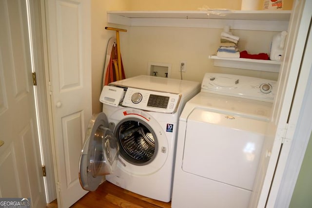 laundry room featuring dark hardwood / wood-style flooring and independent washer and dryer