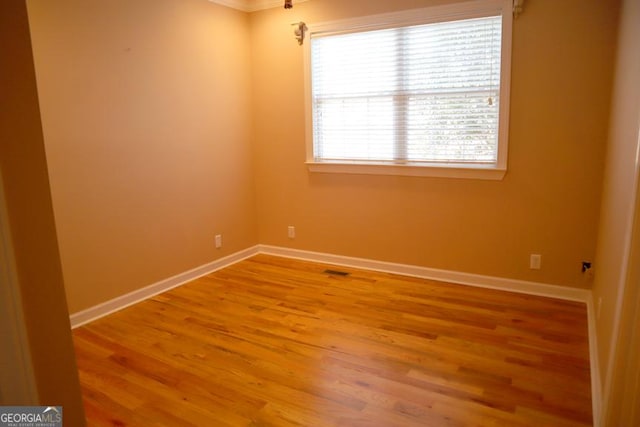 unfurnished room with hardwood / wood-style flooring