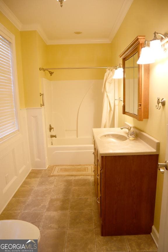 bathroom with crown molding, vanity, tile patterned flooring, and shower / bathing tub combination