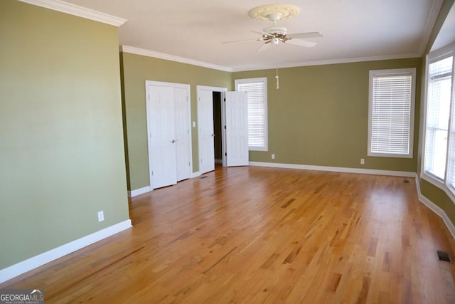 unfurnished bedroom with crown molding, ceiling fan, and light hardwood / wood-style floors