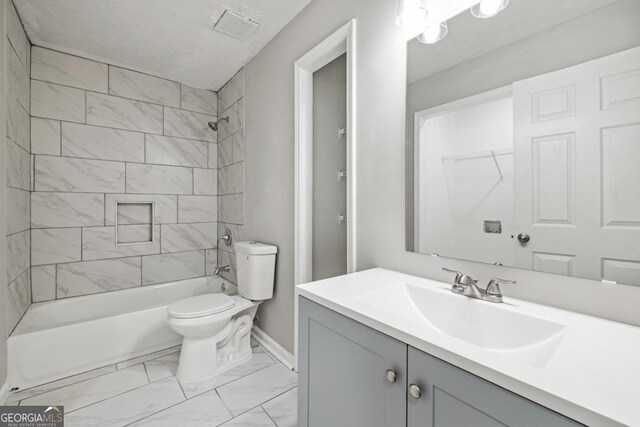 full bathroom featuring vanity, toilet, and tiled shower / bath