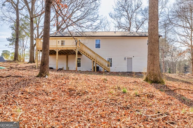 back of property with a wooden deck