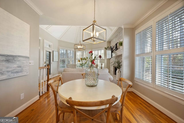 dining room featuring ornamental molding, hardwood / wood-style floors, and a notable chandelier