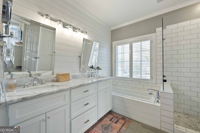 bathroom with independent shower and bath, crown molding, wood-type flooring, and vanity