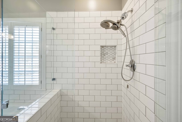 bathroom with a shower with door