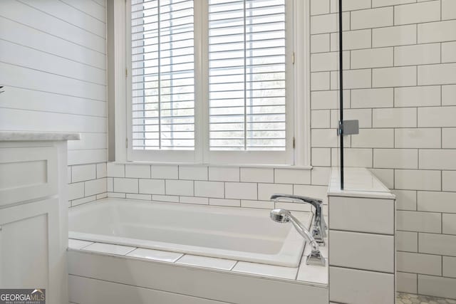 bathroom featuring shower with separate bathtub