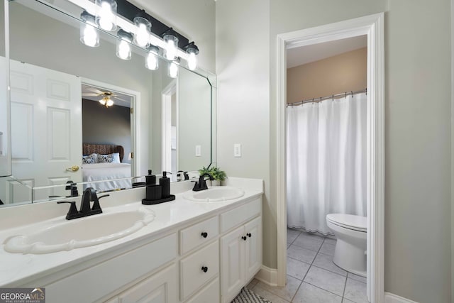 bathroom with tile patterned flooring, vanity, and toilet