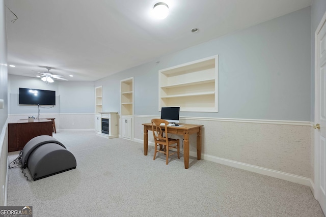 office area with light colored carpet, built in features, and ceiling fan