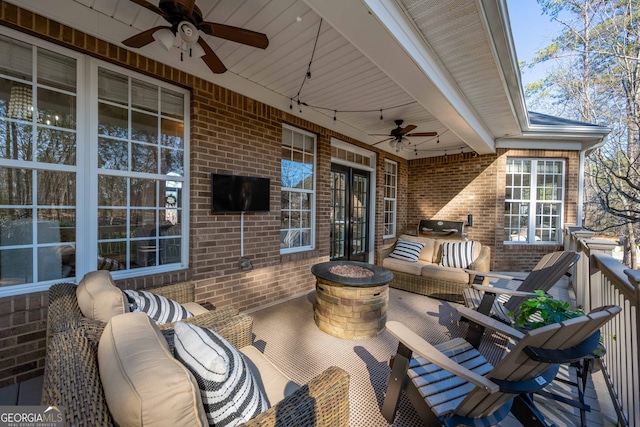 view of patio with an outdoor living space with a fire pit and ceiling fan