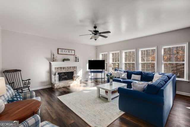 living room with ceiling fan, a fireplace, and dark hardwood / wood-style flooring