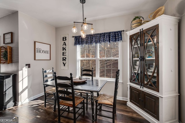 dining area with dark hardwood / wood-style floors