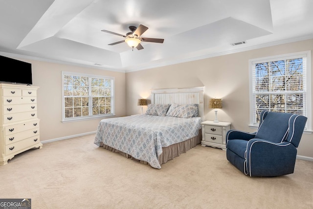 carpeted bedroom featuring crown molding, ceiling fan, and a raised ceiling