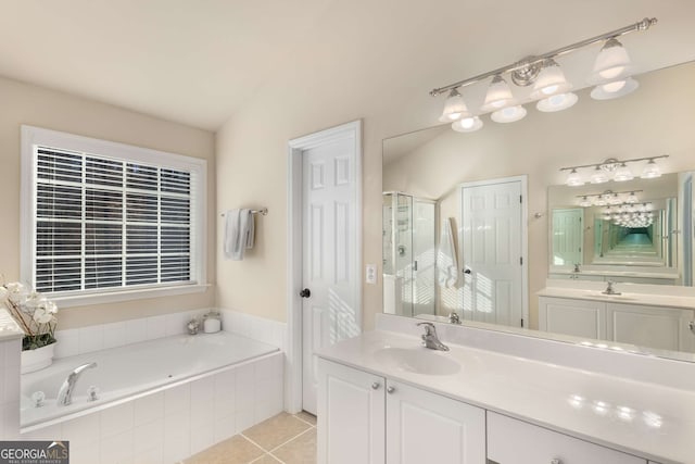 bathroom with vanity, tile patterned flooring, vaulted ceiling, and separate shower and tub