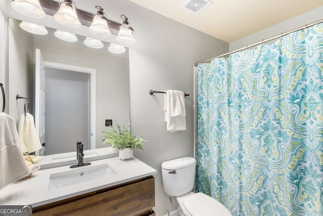 bathroom featuring vanity and toilet