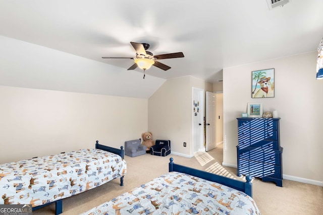 carpeted bedroom with ceiling fan and vaulted ceiling