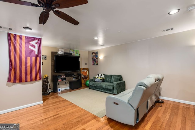 living room with ceiling fan and light wood-type flooring