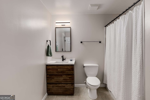 bathroom featuring tile patterned floors, toilet, and vanity