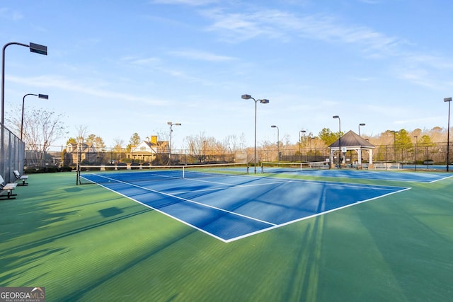 view of tennis court featuring a gazebo