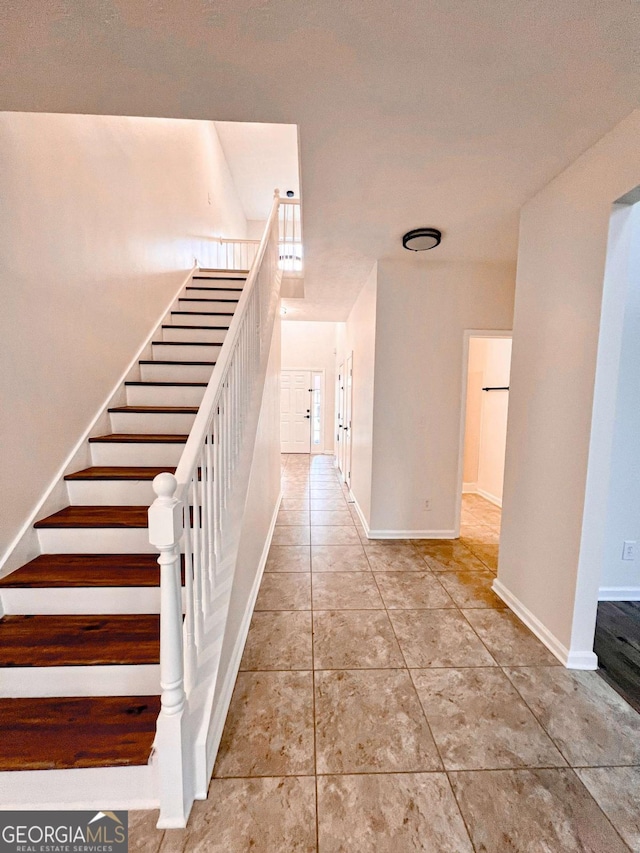 stairs featuring tile patterned floors