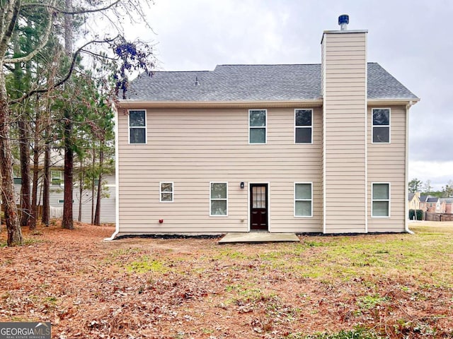 back of house with a yard