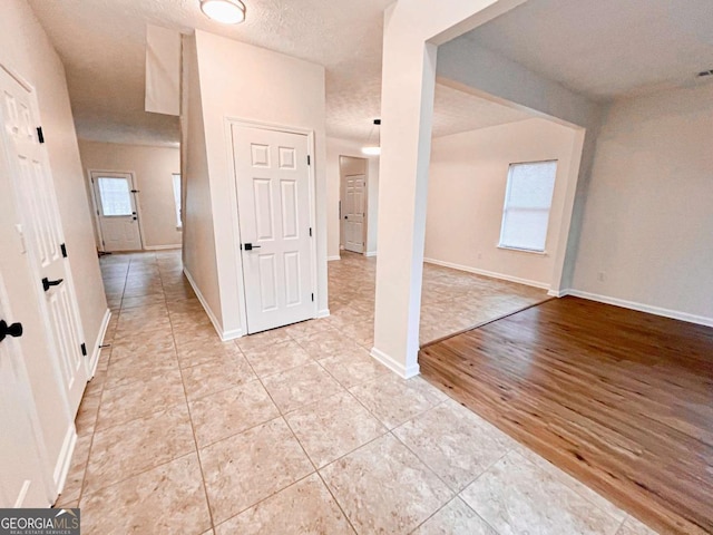 interior space featuring a textured ceiling and light hardwood / wood-style flooring