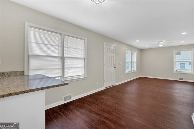 foyer entrance with dark wood-type flooring and ceiling fan