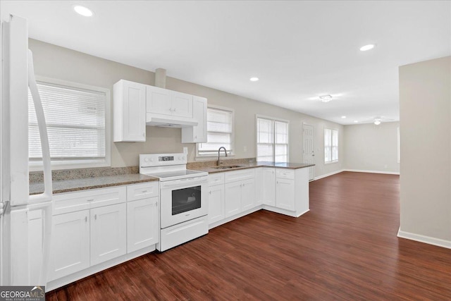 kitchen with sink, white appliances, dark hardwood / wood-style floors, white cabinets, and kitchen peninsula