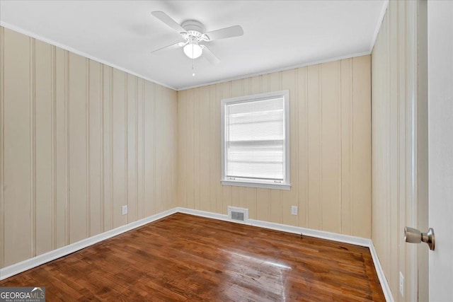 empty room featuring ceiling fan and wood-type flooring