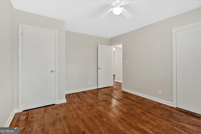 unfurnished bedroom with dark hardwood / wood-style floors and ceiling fan