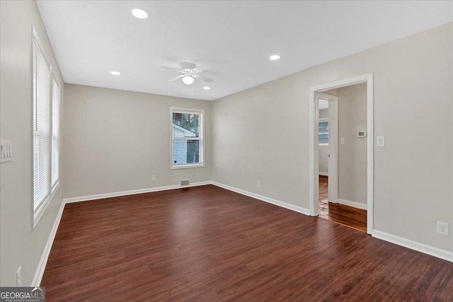 spare room with dark hardwood / wood-style flooring and ceiling fan