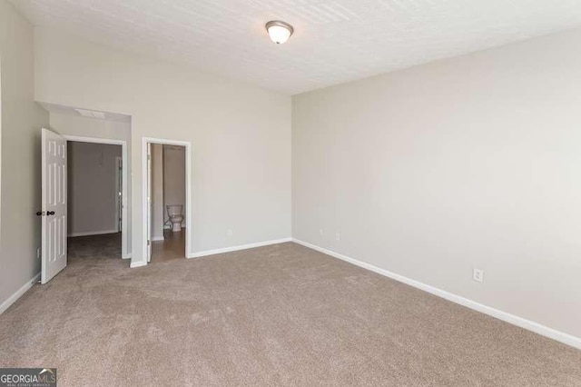 unfurnished bedroom featuring carpet flooring and a textured ceiling